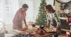 Portrait of Adult Mother and Daughter Preparing Christmas Dinner for Guests.