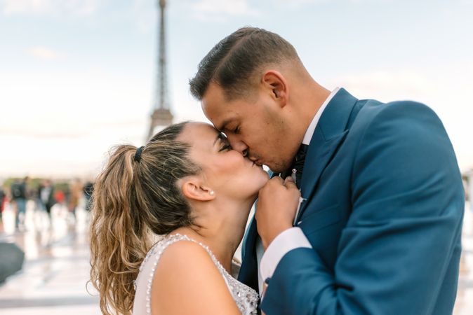 Happy newlyweds in wedding clothing kissing