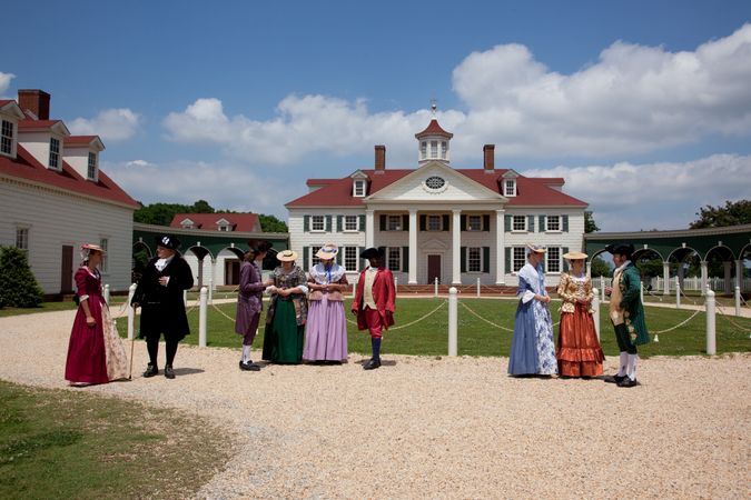 Actors in period costume reenact scene at historic American Village in Alabama