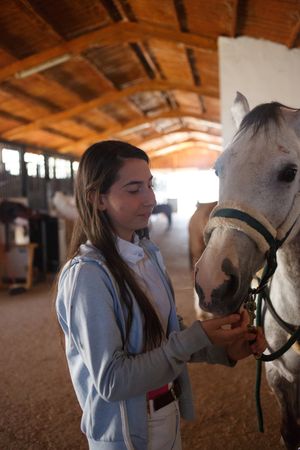 Girl with adorable pony in hat