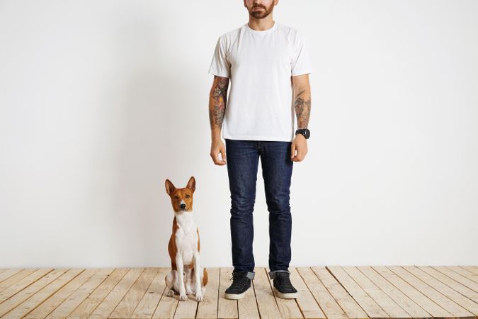 Man and dog standing in empty room