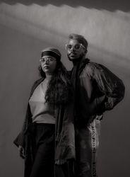 Man and woman in casual wearing standing in grayscale