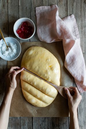 Faceless cook preparing Spanish pie coca San Juan