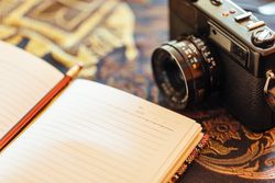 Notebook next to a vintage camera