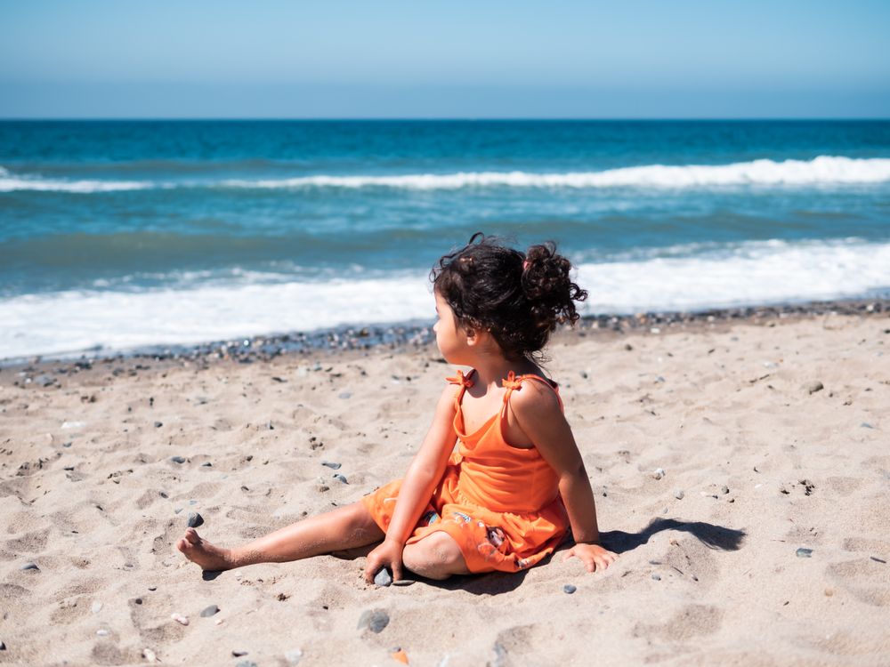 Little girl sitting on beach