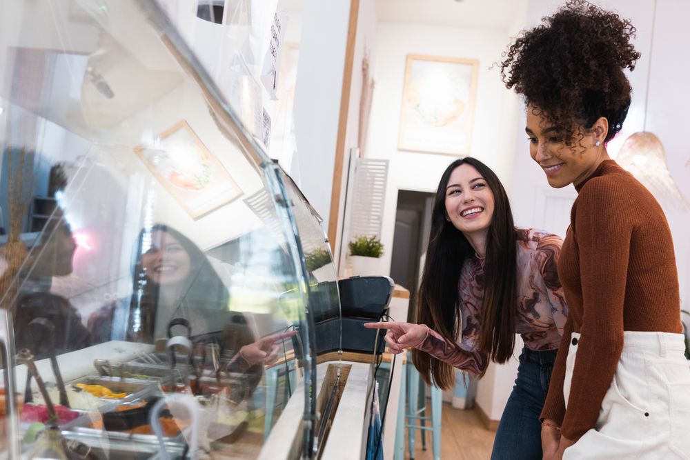 Multiethnic women choosing food in restaurant