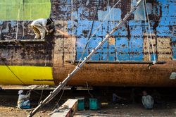 Workers welding parts of ship in Bangladesh