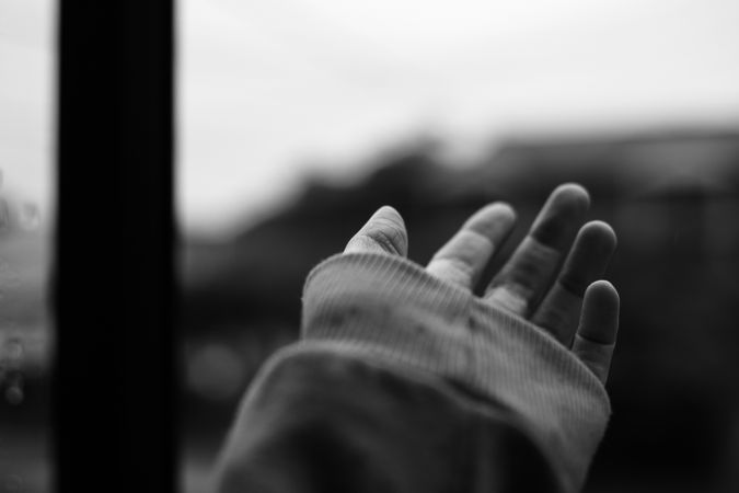 Grayscale photo of person's hand