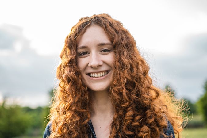 Joyful redhaired woman outdoors