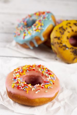 Delicious assorted colorful donuts on the table.