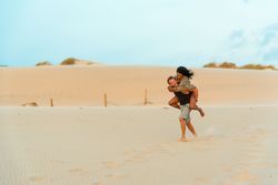 Piggyback, having fun at beach