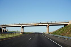 Bridge above road with height mentioned on board