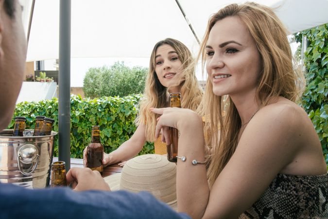 Group of friends drinking beer on the terrace of a bar
