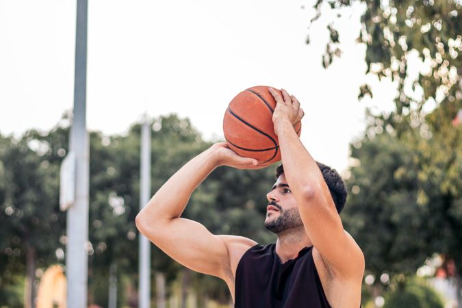 Game On: Young Man Ready to Shoot Hoops