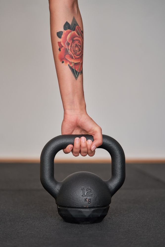 Anonymous woman holding metal kettlebell