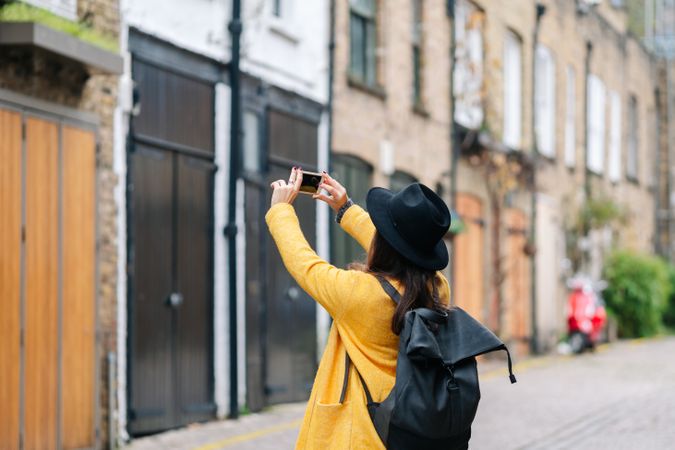 Anonymous traveler taking picture of building