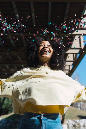Woman throwing confetti in the air.