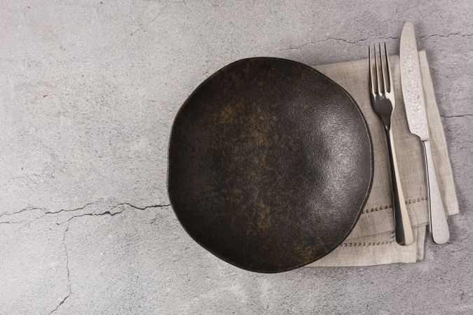 Empty plate on the slate table. Top view of the image.