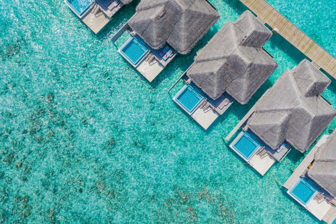 Aerial shot of patio pool of thatched beach villas