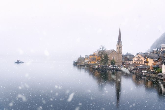 Snow over lake and quaint village
