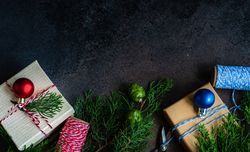 Top view of wrapped Christmas presents with fir and string