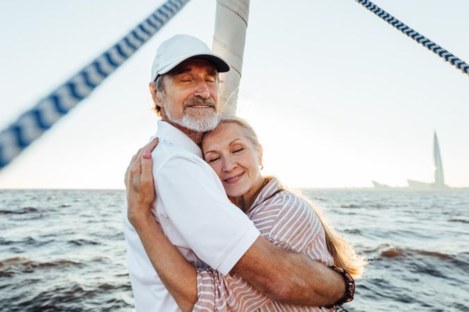 Mature man and woman hugging on a boat