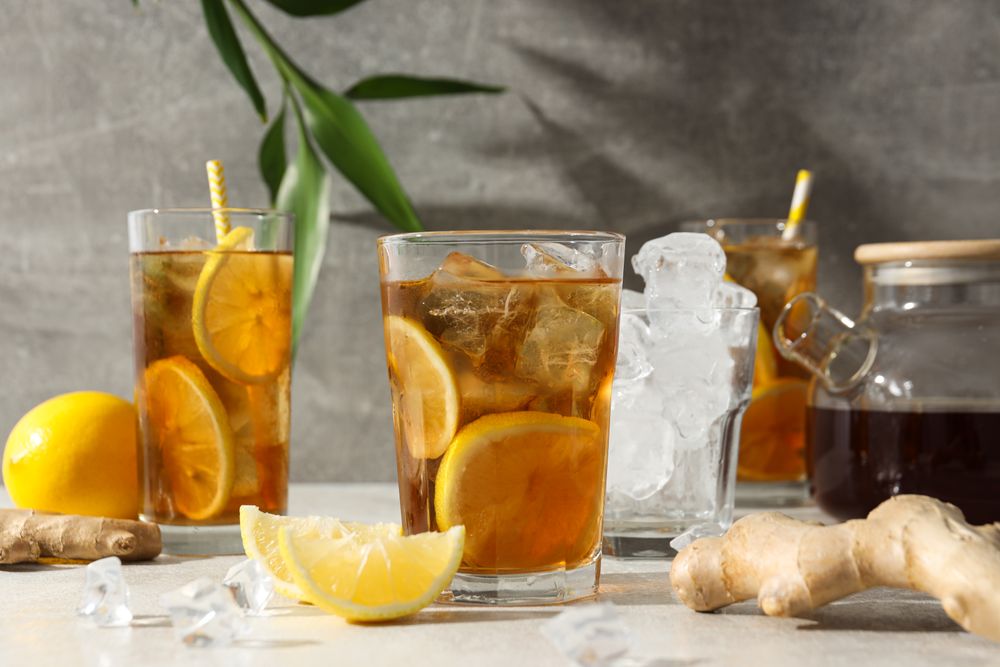 Cold tea with ice, orange slices and mint leaves and ginger
