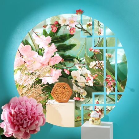 Chinese mooncake surrounded by vibrant flowers