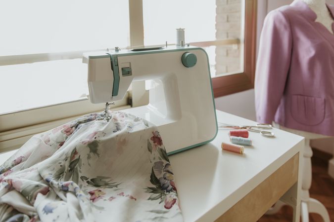 Dummy with blouse near sewing machine