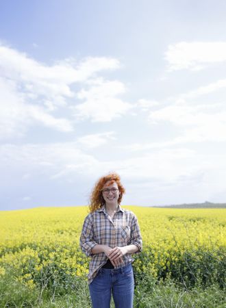 Red haired woman in a field, vertical