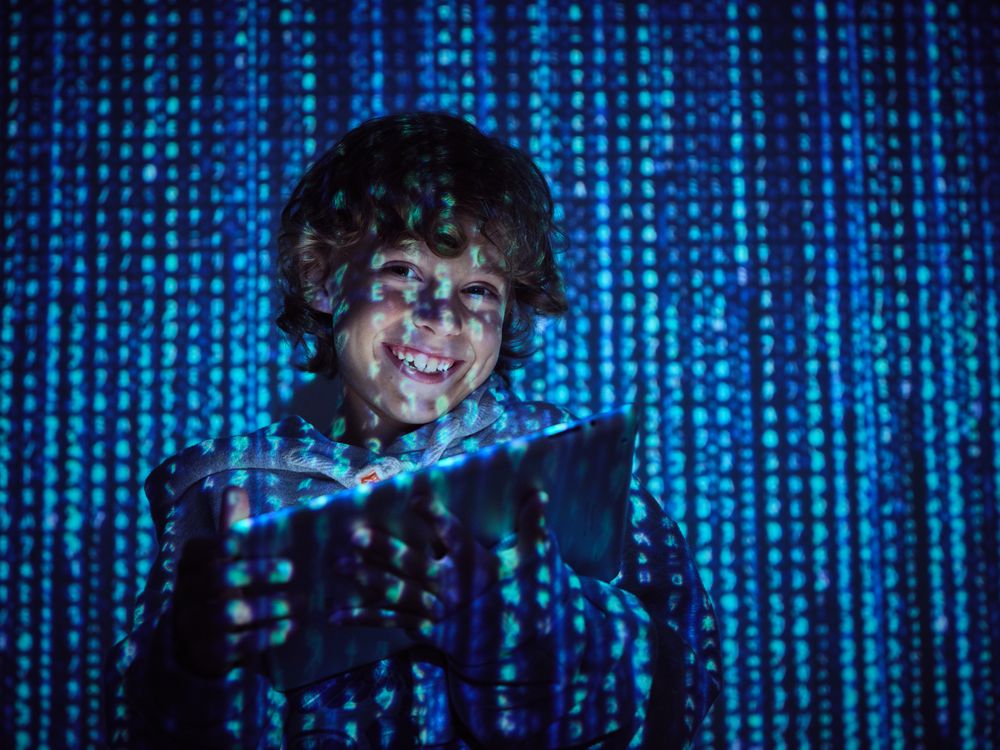 Cheerful hacker with digital tablet