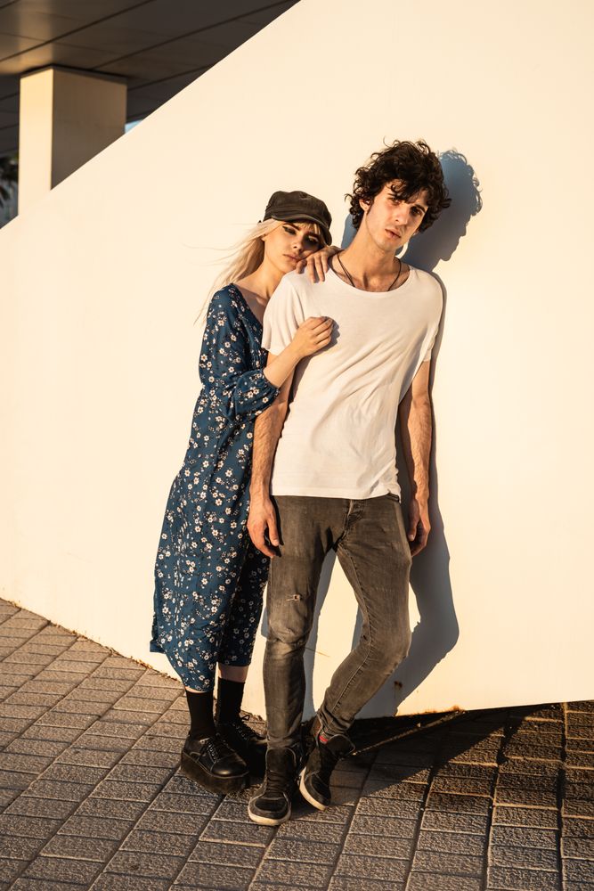 Couple leaning on wall contemplating