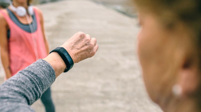 Woman looking smart watch with female coach