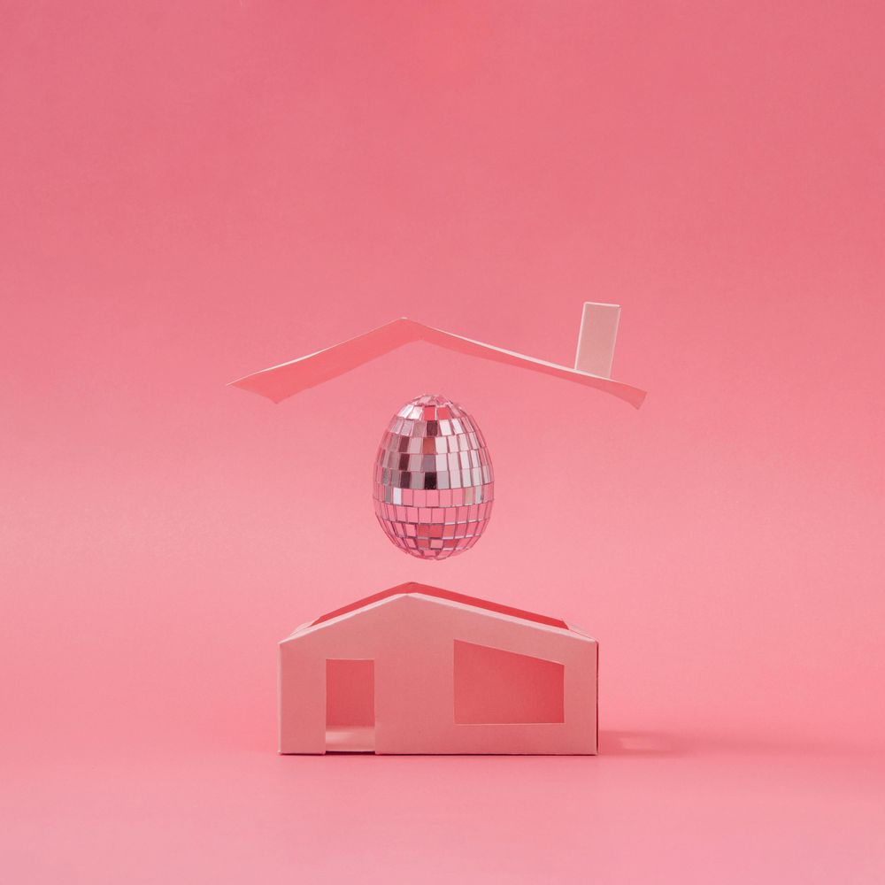 Pink disco ball Easter egg above minimalistic house