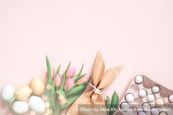Flat lay of Easter eggs, tulips and paper bag with copy space bGrEA4