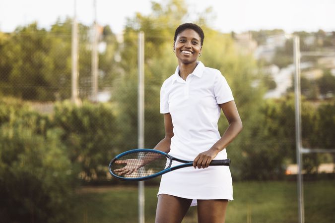 Young woman playing tennis match