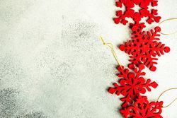 Flat red Christmas star ornaments on marble