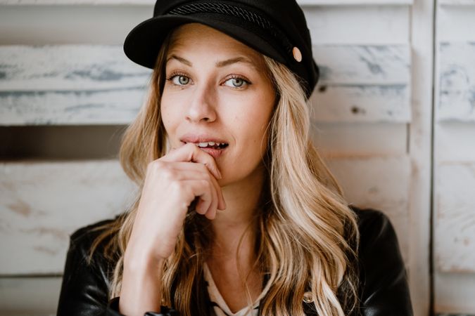 Woman thoughtfully looking away touching lips