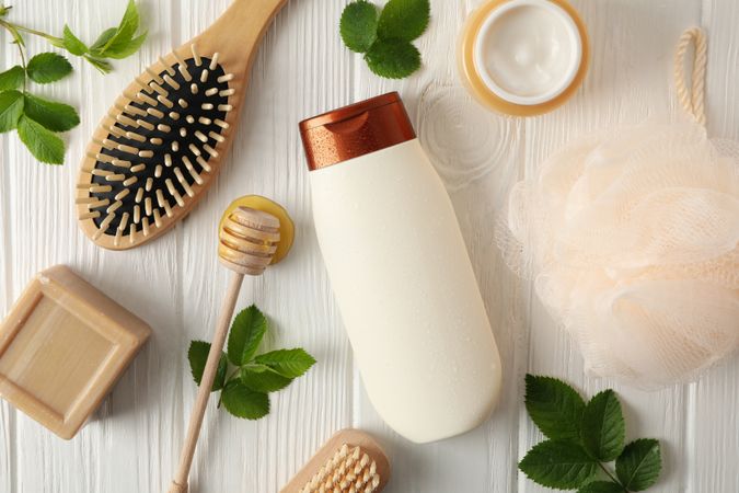 Composition with hair care products on wooden background, top view