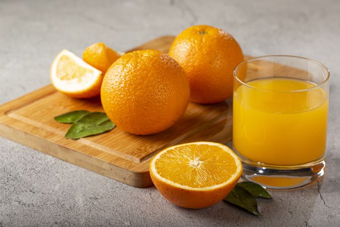 Glass with orange juice on the table.