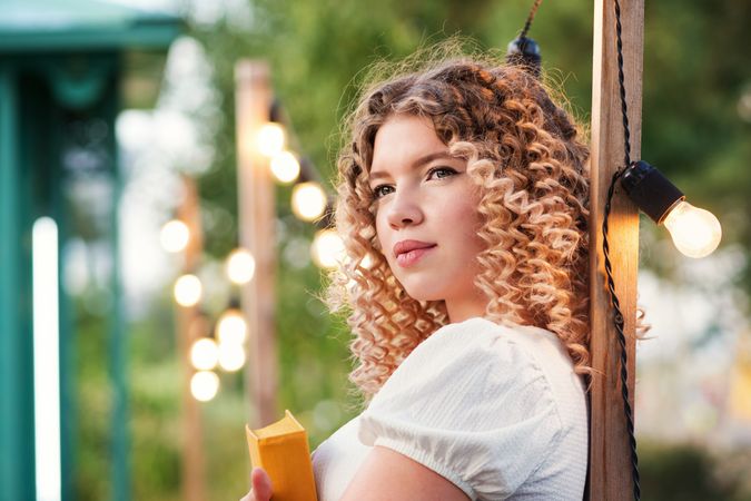 Woman with book outdoors
