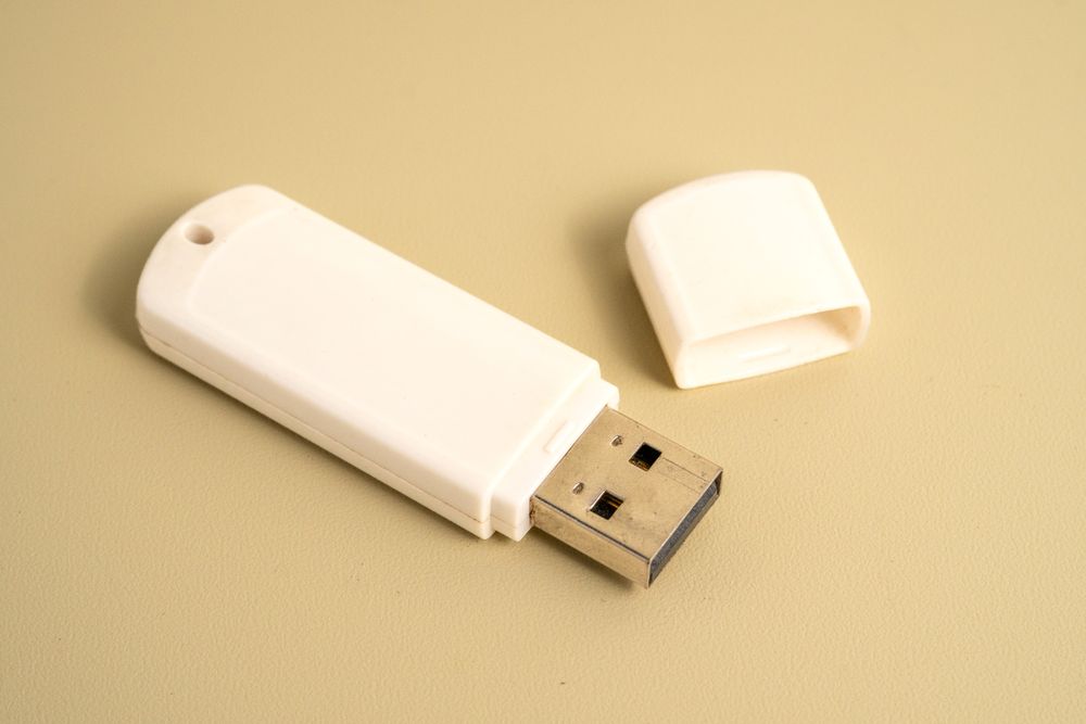 A USB flash drive is open and laying on a table