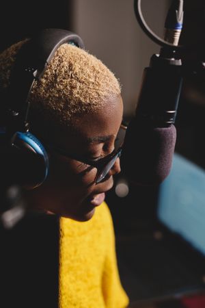Serious Black female radio host talking in microphone