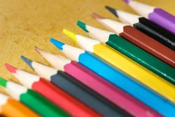 Coloured pencils for drawing on a yellow background