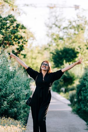 Cheerful female walking in park