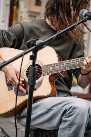 Faceless male musician performing in the street