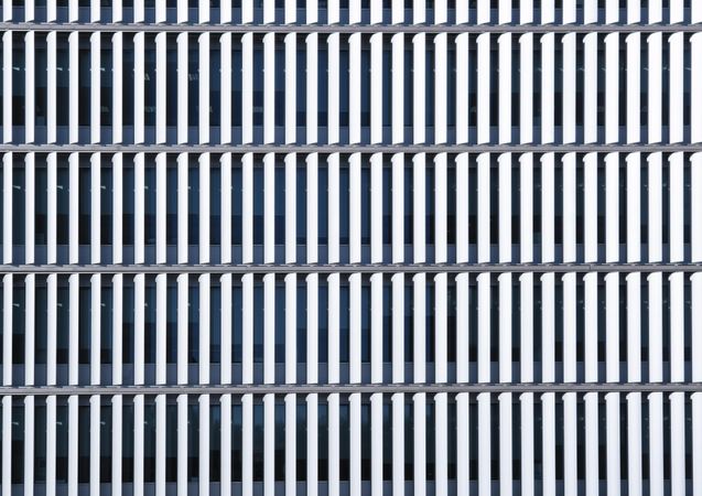 Close up of ordered window shades on city building