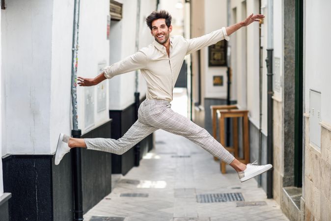 Young joyful man jumping in the street.