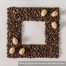 Frame of coffee beans with scattered eggs 0KVvVb