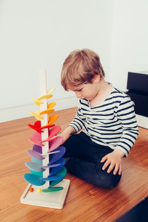 Boy playing with wooden construction pieces